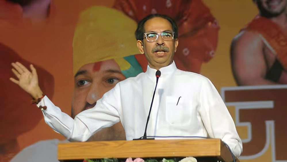 Shiv Sena (UBT) chief Uddhav Thackeray addresses supporters at a rally.