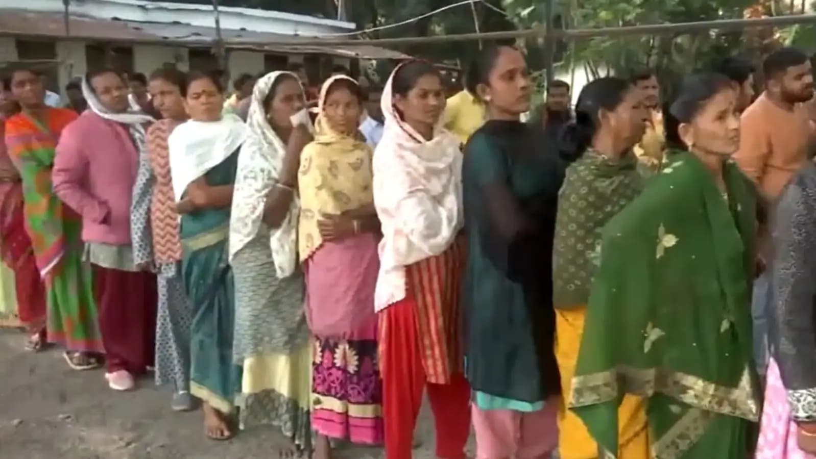 Voters queue up outside a polling booth in Kondagaon as they await their turn to cast a vote in the first phase of Assembly elections