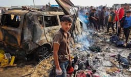 A boy standing in the rubble after Israel attacked a camp in Rafah on May 26.