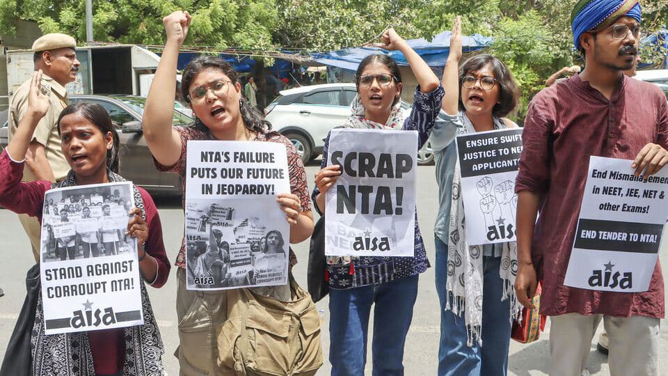 Members of the All India Students Association (AISA) protest over the alleged irregularities in medical entrance exam NEET, at Shastri Bhawan, in New Delhi.