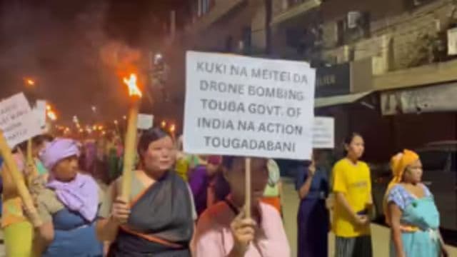 Residents of Khurai Lamlong in Imphal East district stage a torch rally to condemn the recent drone attack by militants. 