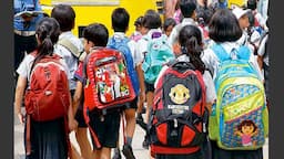 School students carrying backpacks as Kerala considers measures to reduce school bag weight.